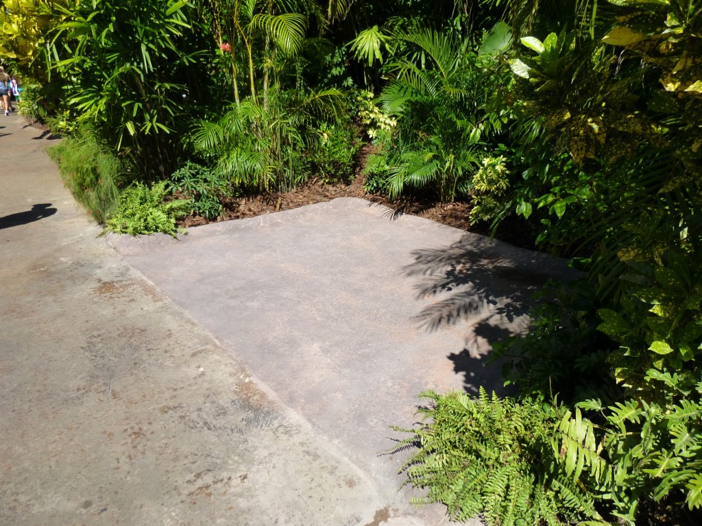 Concrete has been filled in where the Jurassic Park arch was, so no more potted plants.