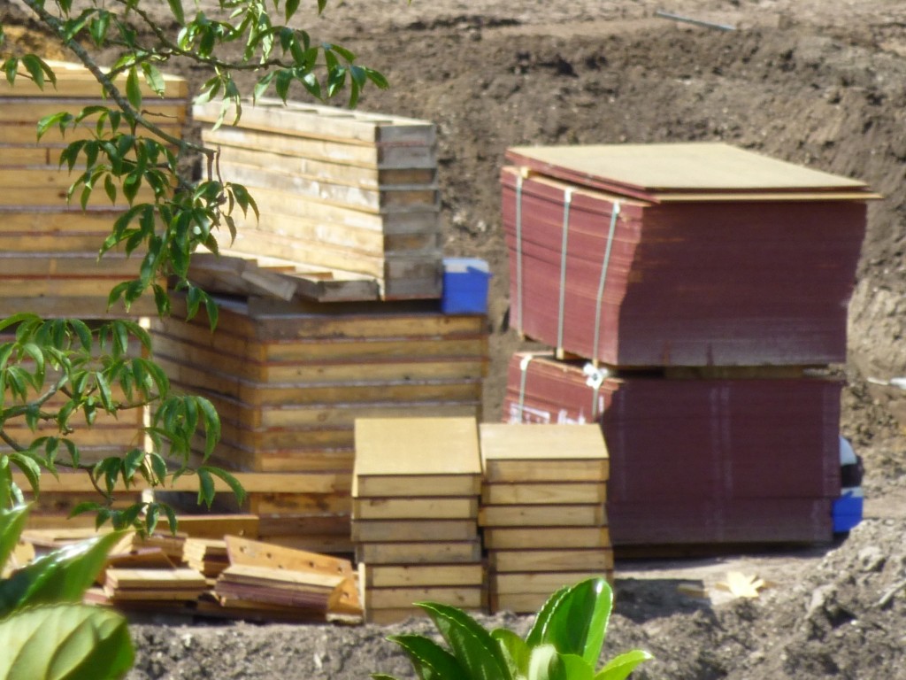 Piles of wood, with what appears to be someone's lunchboxes?