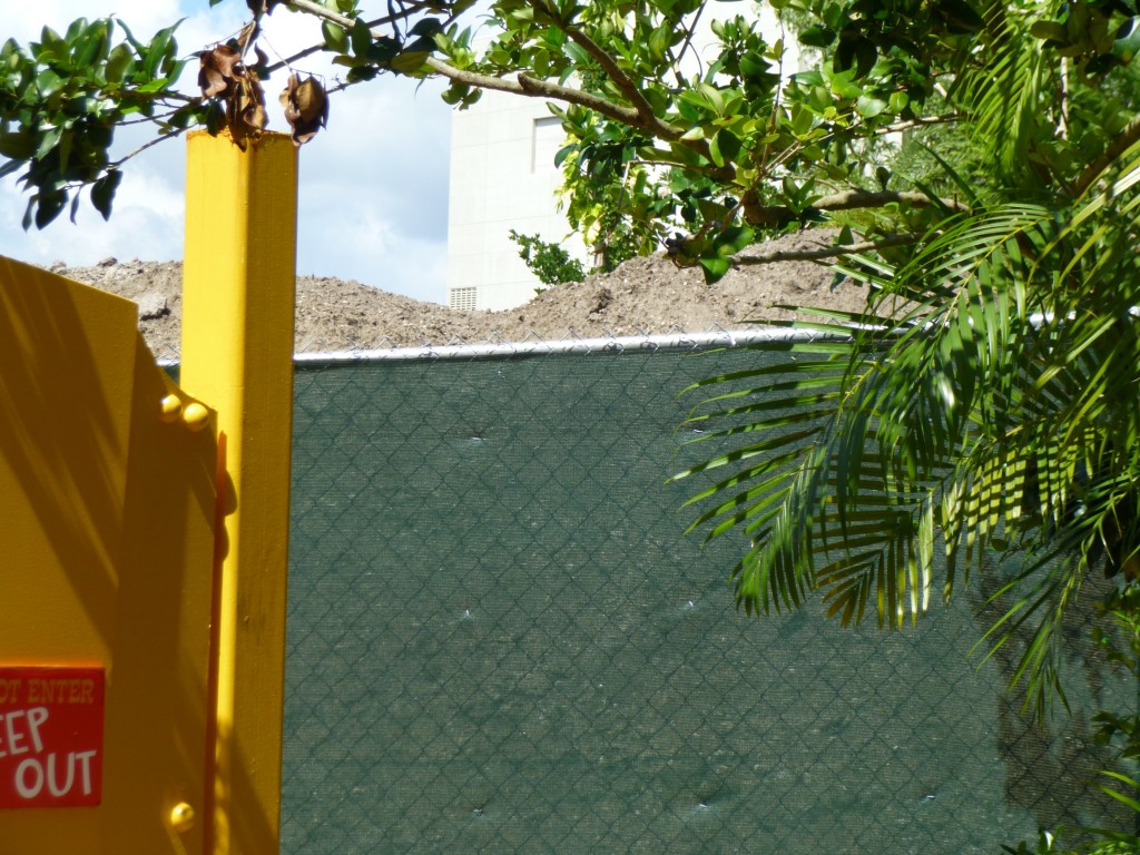 Piles of displaced dirt line the fence near Toon Lagoon