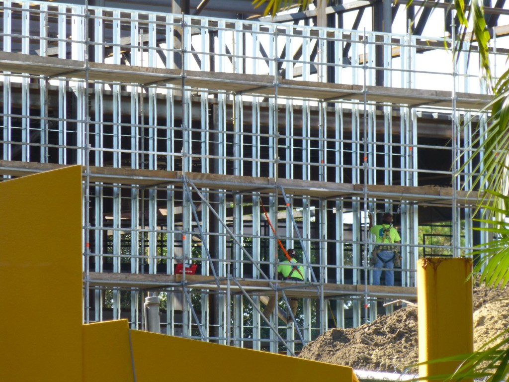 Workers installing studs for wall