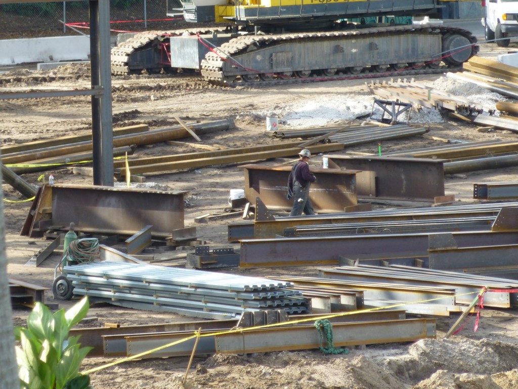 New steel beams and siding arriving every day to keep the behemoth growing.