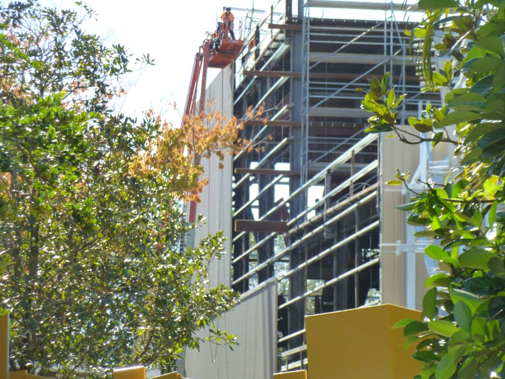 Wall siding going up on the sides of the building to match the front.