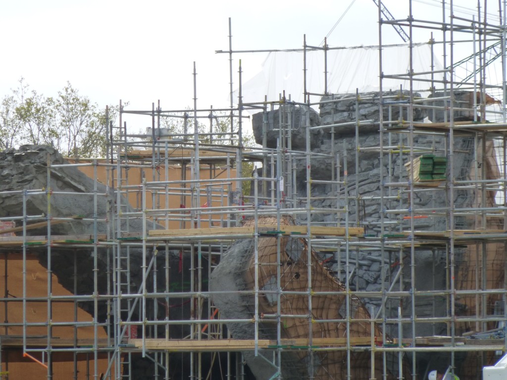 Brickwork being carved near the top-left side of the facade