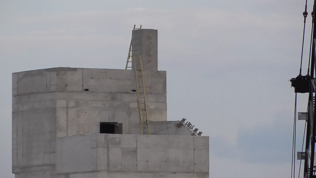 Tower beside volcano, perhaps stairs/elevator to rides and lookout perch