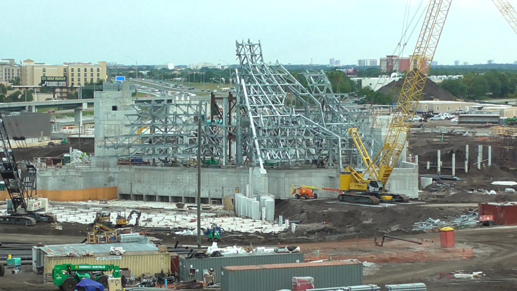 Concrete tower is being built alongside volcano, on the left