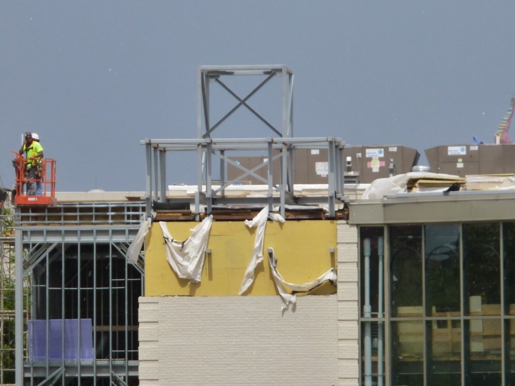 Large decorative area being worked on on left side of building