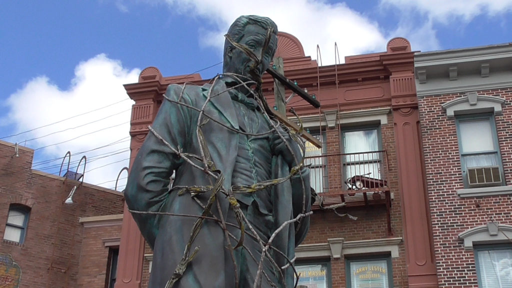 Lew Wasserman statue covered in vines in New York for Horror Nights