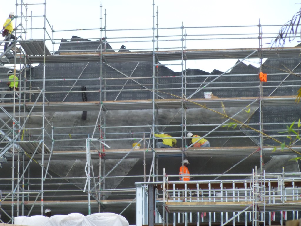 Workers refining the two-dimensional facade