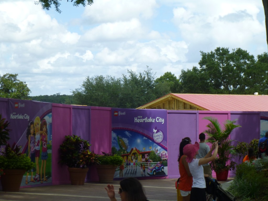 You can see the stable shaped ride entrance over the fence, with the concept art on the sign in front