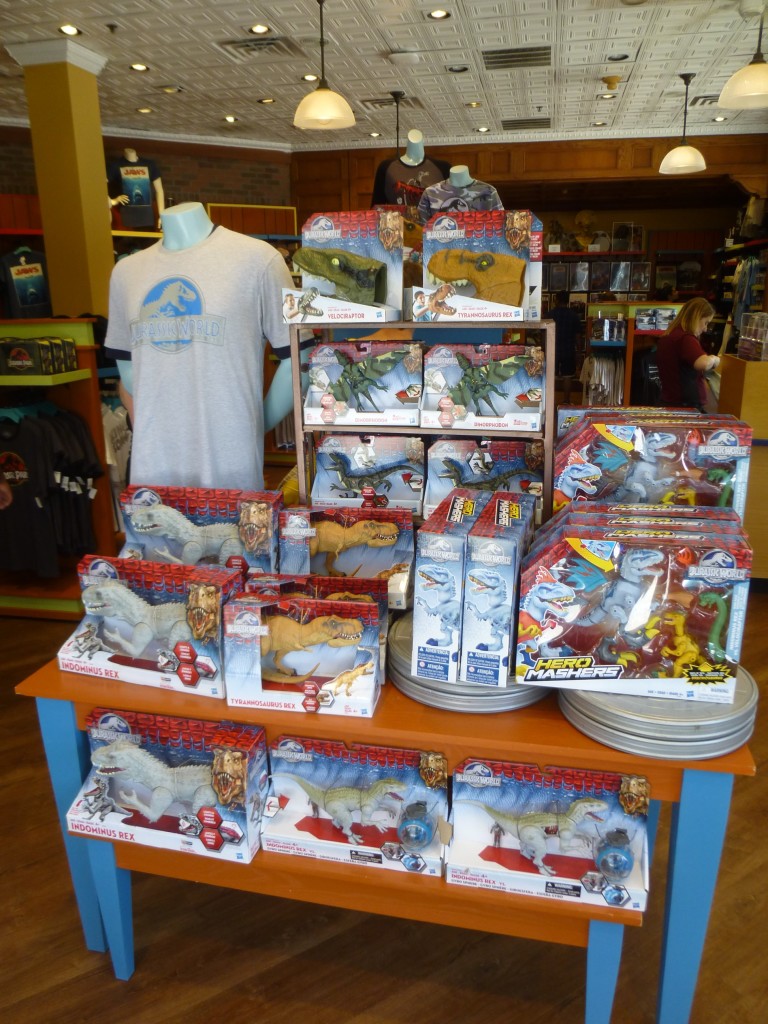 Jurassic World Hasbro toys and the adult logo shirt at the entrance