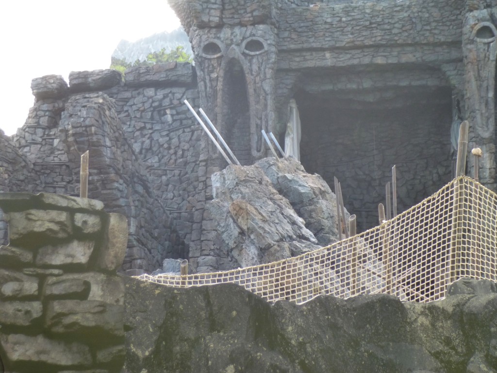 Large rock centerpiece in center of outdoor track, rising up in front of temple gates