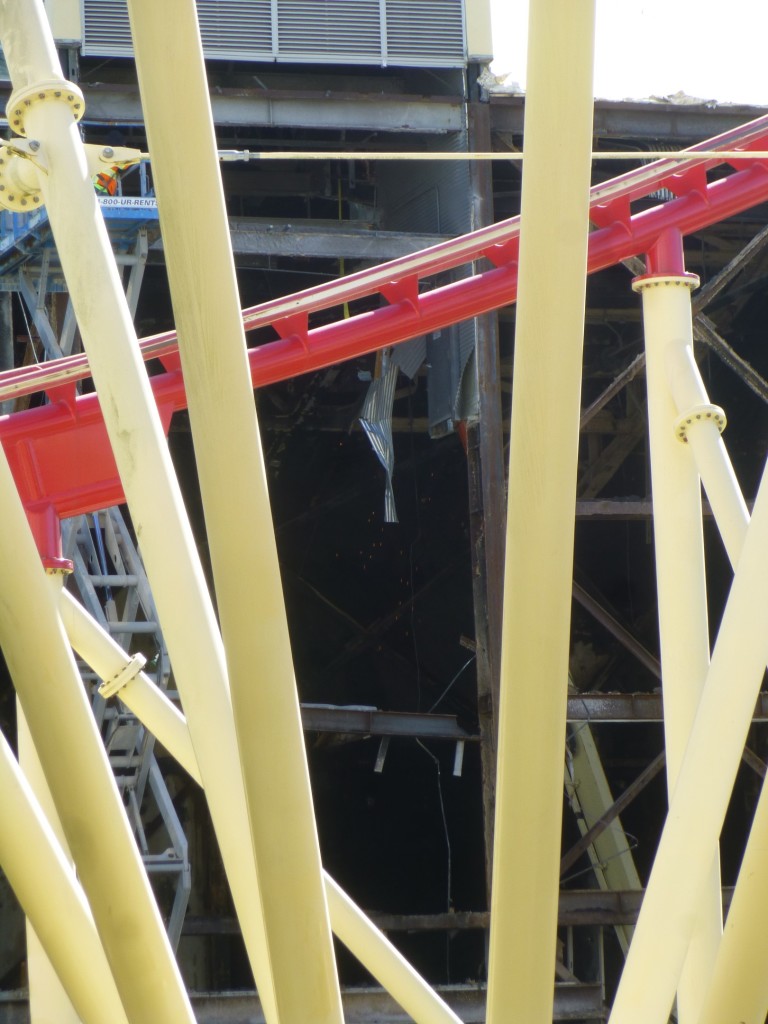 Workers tearing out the old cyclone venting system on the ceiling