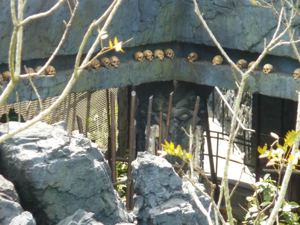 Skulls along roof of covered outdoor queue area behind entrance
