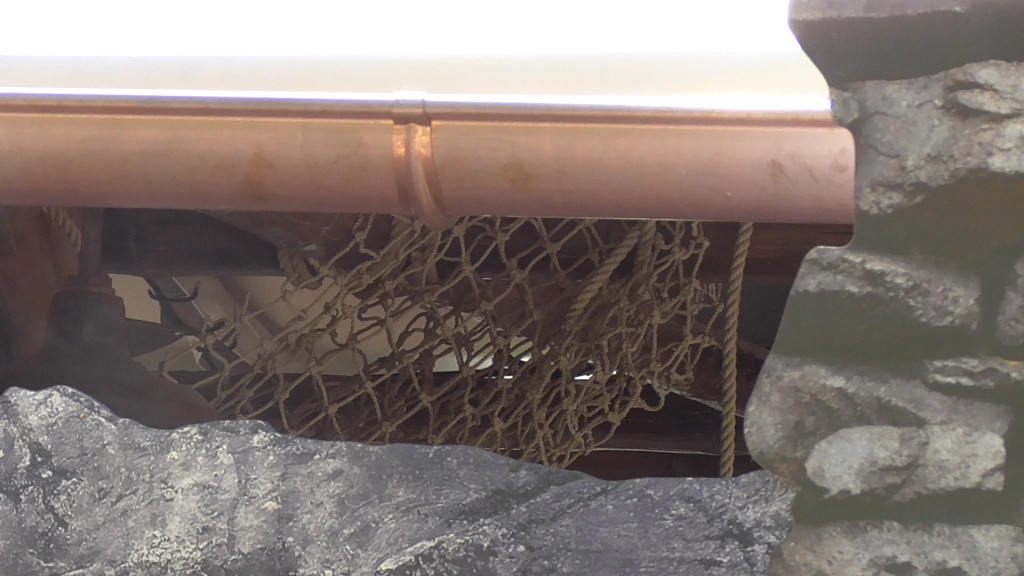 Nets and rope being added to food stand for theming accents