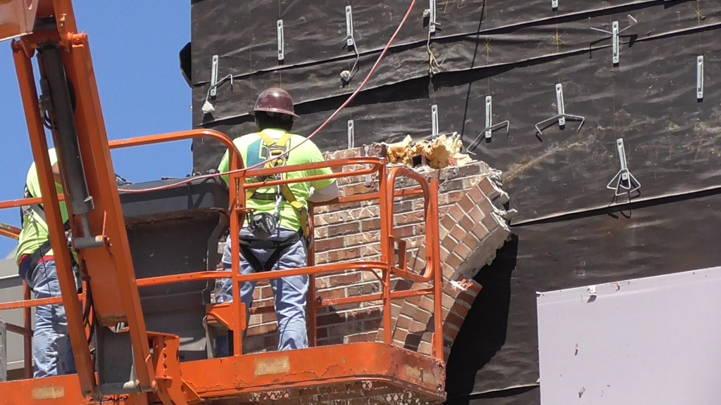 Closer view of the bricks being stripped off
