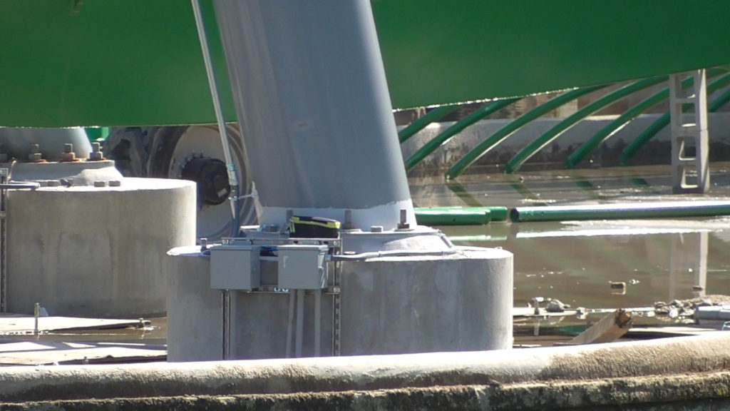 Finished electrical boxes on footer with roof for underwater track tunnel in background, not yet installed