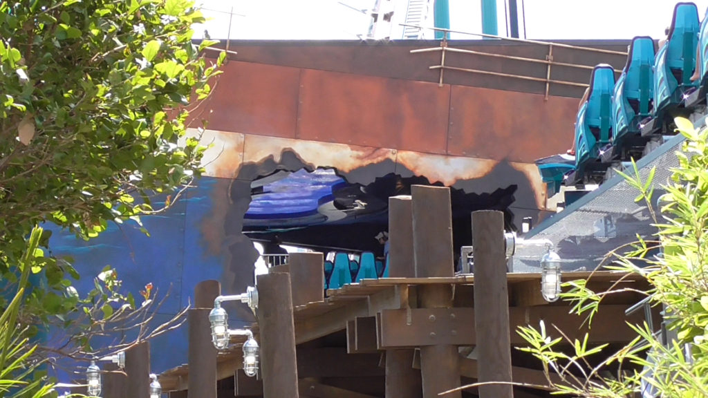 Ride ends passing through the rusted hull of a sunken ship