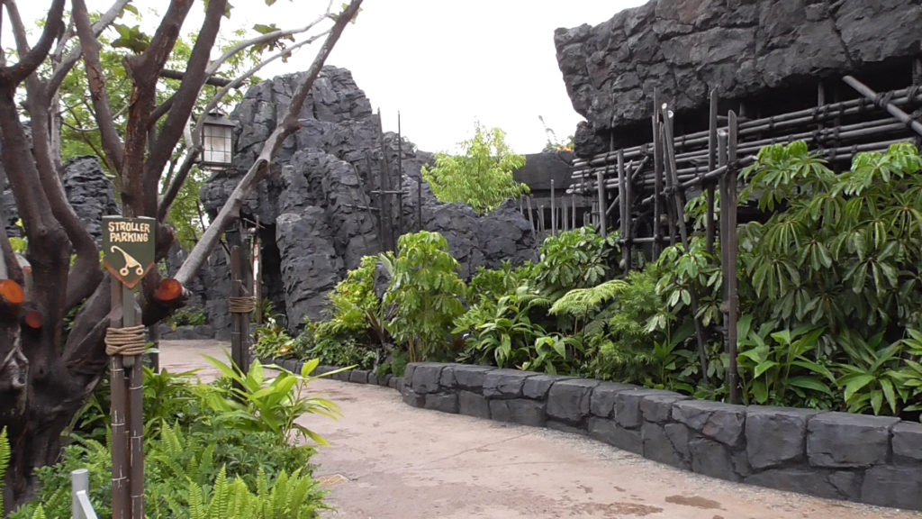 Walkways and stroller parking behind ride sign