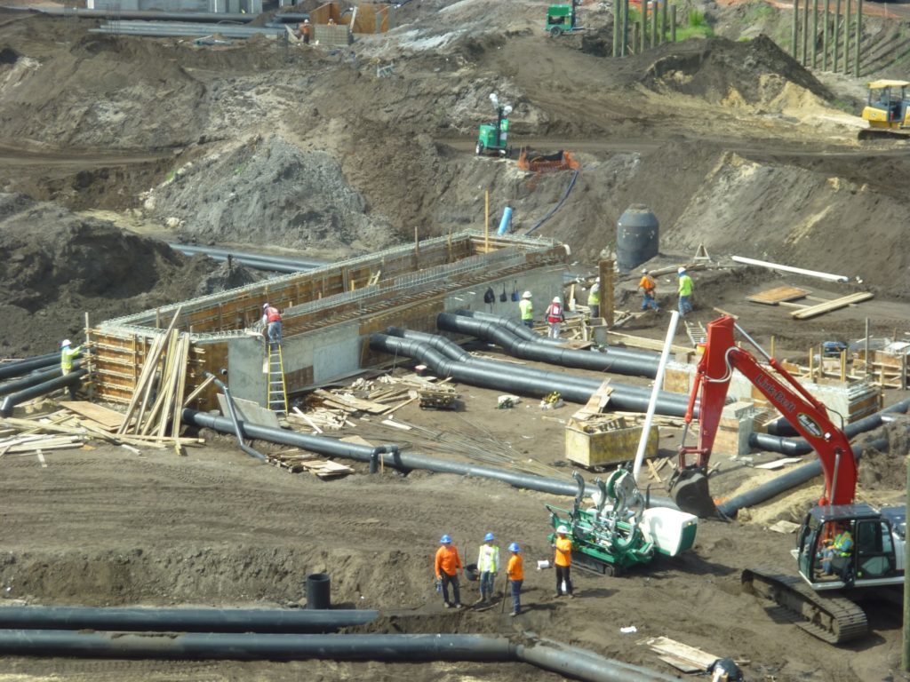 What looks to be a water pump station being built in the middle of the park