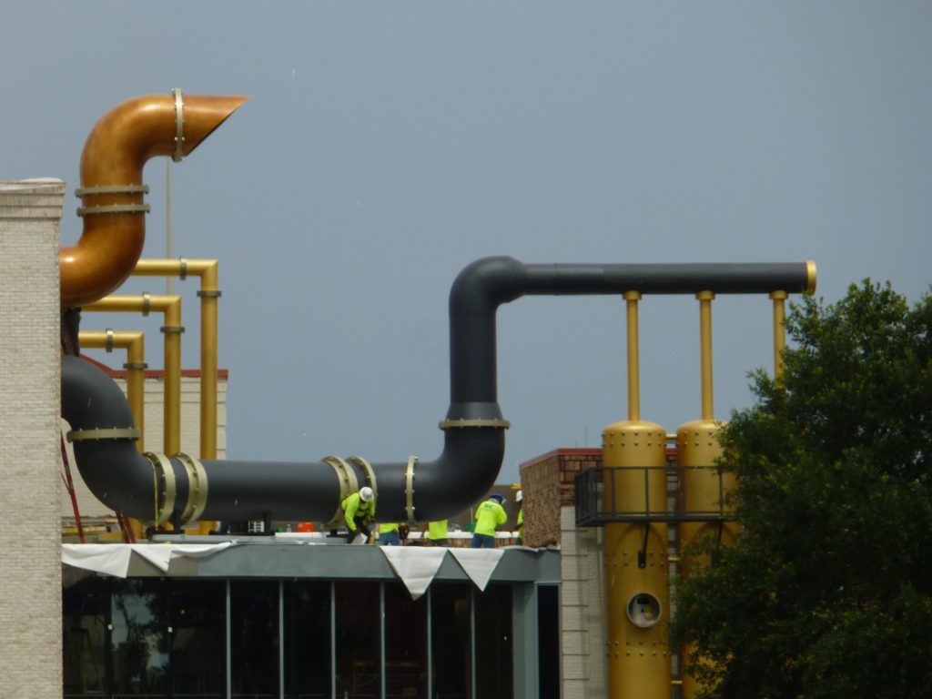 Workers adding new touches to pipes