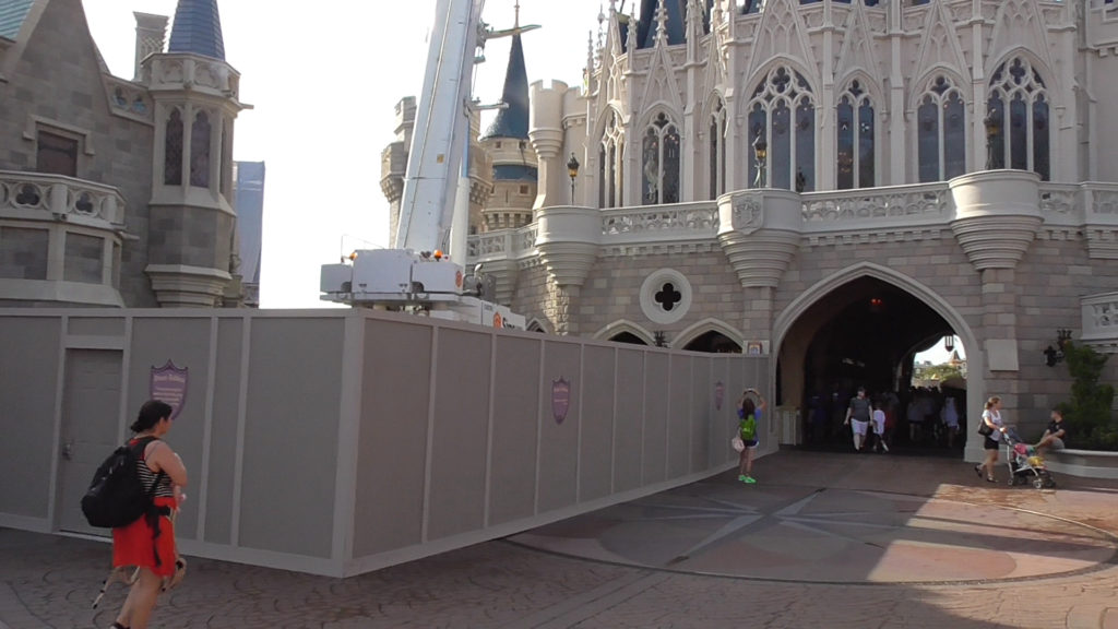 Work walls and crane behind Cinderella Castle