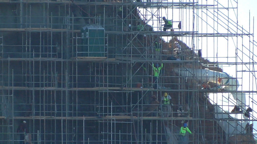 Workers and port-a-pottys on mountain side