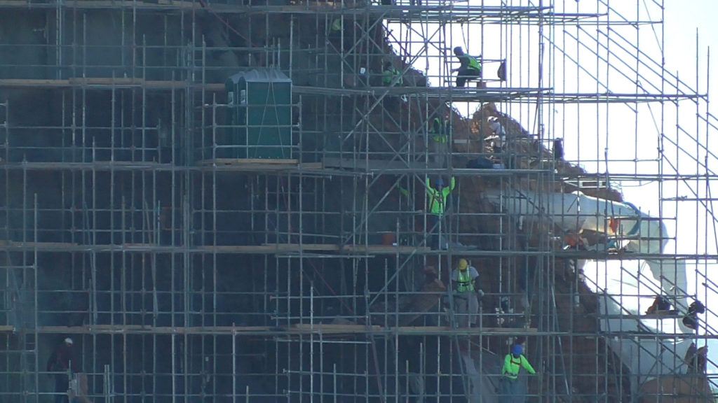 Workers and port-a-pottys on mountain side