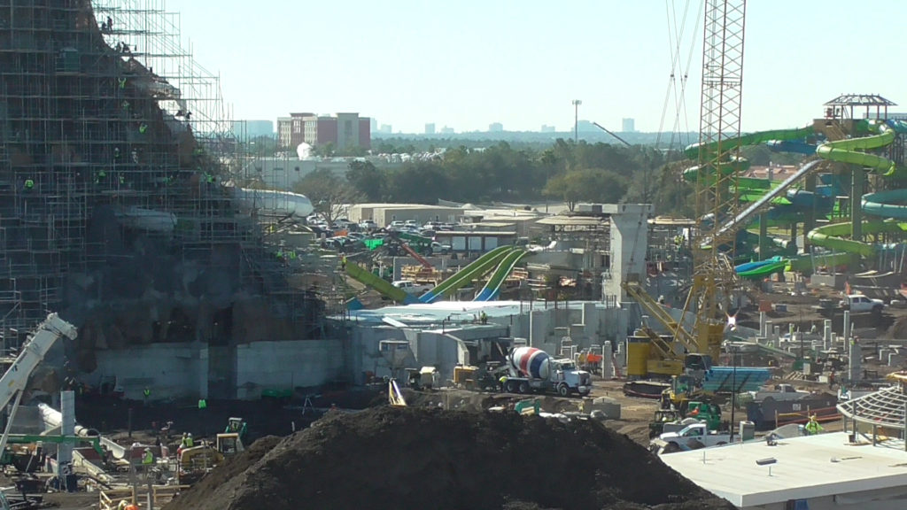 Wide view of water coaster behind volcano